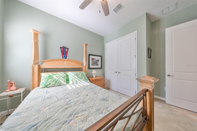 carpeted bedroom featuring ceiling fan and a closet