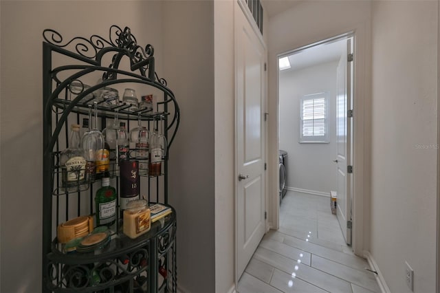 hall with light tile patterned floors