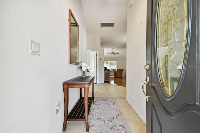 tiled foyer entrance featuring ceiling fan