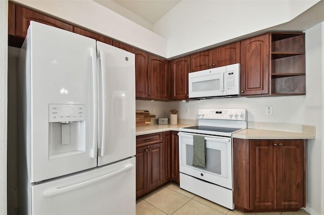 kitchen with light tile patterned floors and white appliances