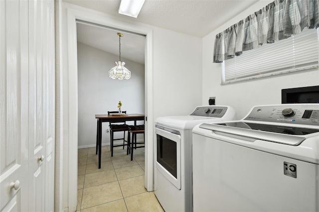 washroom featuring independent washer and dryer and light tile patterned flooring