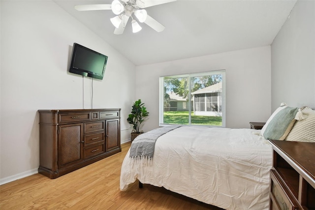 bedroom with ceiling fan, lofted ceiling, and light hardwood / wood-style floors