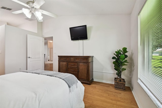 bedroom with ceiling fan, light hardwood / wood-style flooring, and lofted ceiling