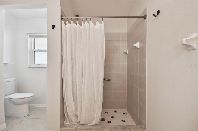 bathroom featuring toilet, a shower with curtain, and tile patterned flooring