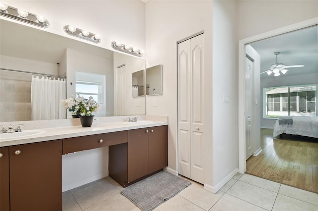 bathroom featuring ceiling fan, plenty of natural light, tile patterned floors, and vanity