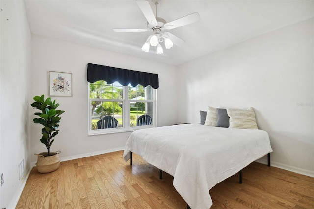 bedroom with light wood-type flooring and ceiling fan