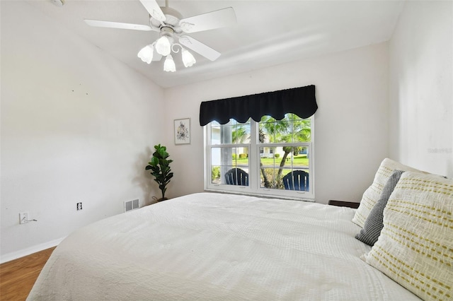 bedroom with ceiling fan and hardwood / wood-style floors