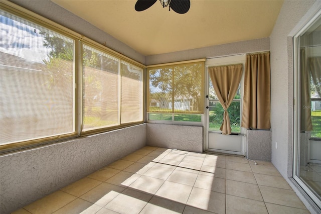 unfurnished sunroom with ceiling fan