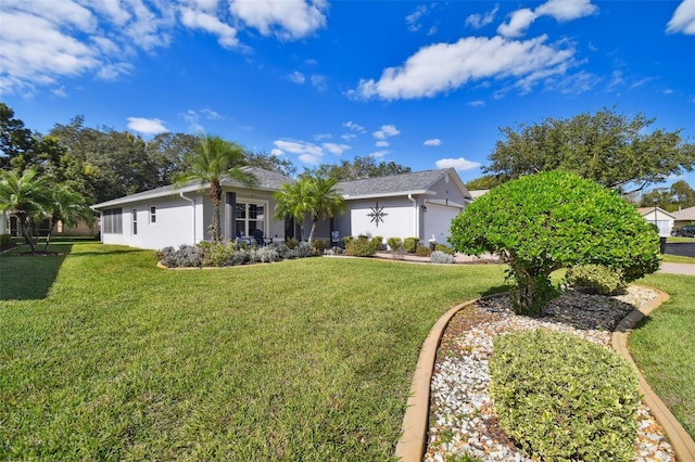 view of front of home with a front yard and a garage