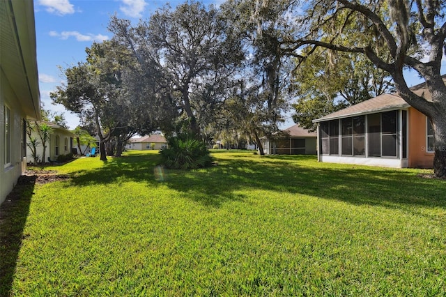 view of yard featuring a sunroom