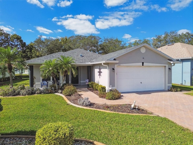 ranch-style house featuring a front yard and a garage