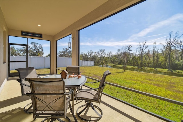 sunroom / solarium with a water view