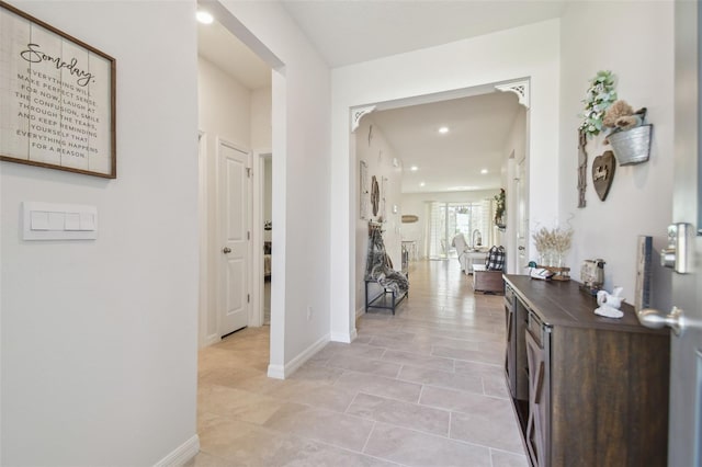 hall featuring light tile patterned floors