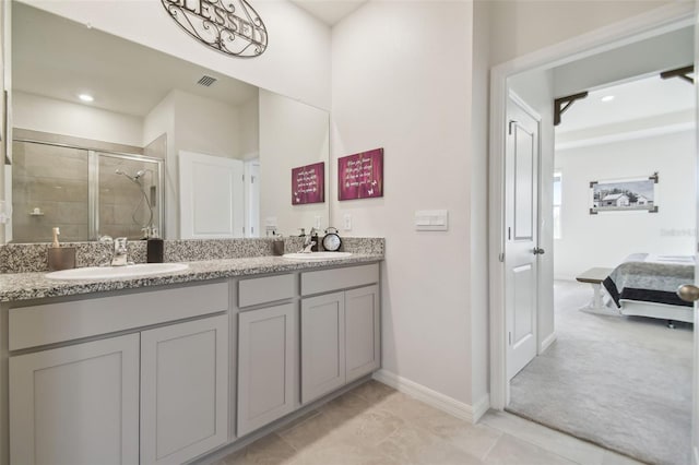 bathroom featuring vanity, tile patterned floors, and a shower with shower door