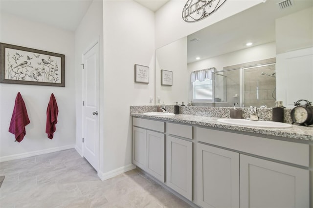 bathroom featuring vanity and a shower with shower door