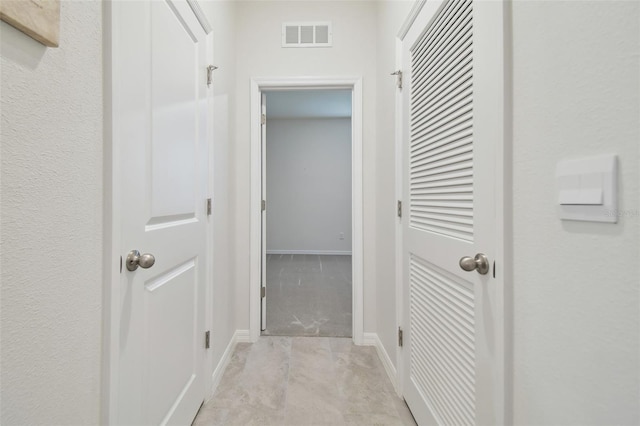 hallway with light colored carpet