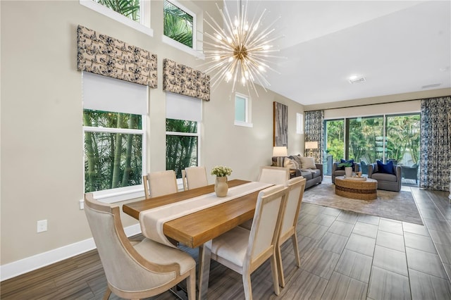 2246 Fiesta Dr, Sarasota, FL 34231 - dining space featuring a chandelier and wood finished floors