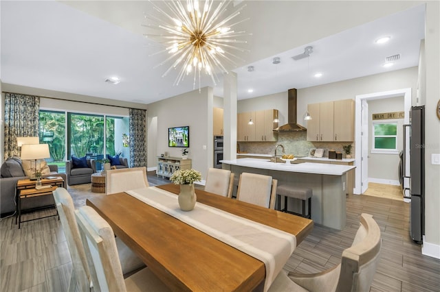 2246 Fiesta Dr, Sarasota, FL 34231 - dining area with a chandelier, recessed lighting, and wood tiled floors