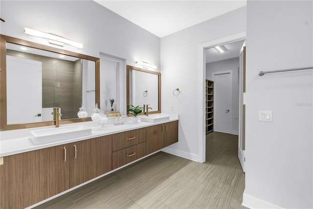 2246 Fiesta Dr, Sarasota, FL 34231 - bathroom featuring double vanity, a spacious closet, and a shower
