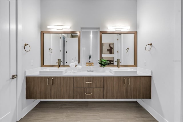 2246 Fiesta Dr, Sarasota, FL 34231 - bathroom featuring double vanity and wood finished floors