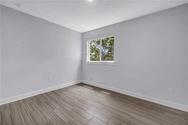 2246 Fiesta Dr, Sarasota, FL 34231 - spare room featuring baseboards and wood finished floors