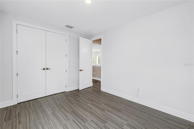 2246 Fiesta Dr, Sarasota, FL 34231 - unfurnished bedroom with a closet and wood finished floors