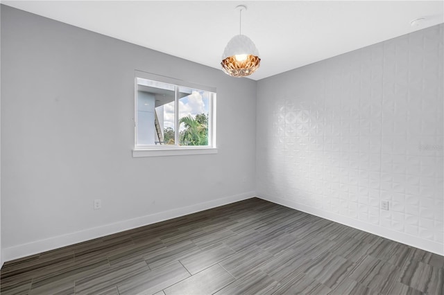 2246 Fiesta Dr, Sarasota, FL 34231 - spare room featuring wood finished floors and baseboards