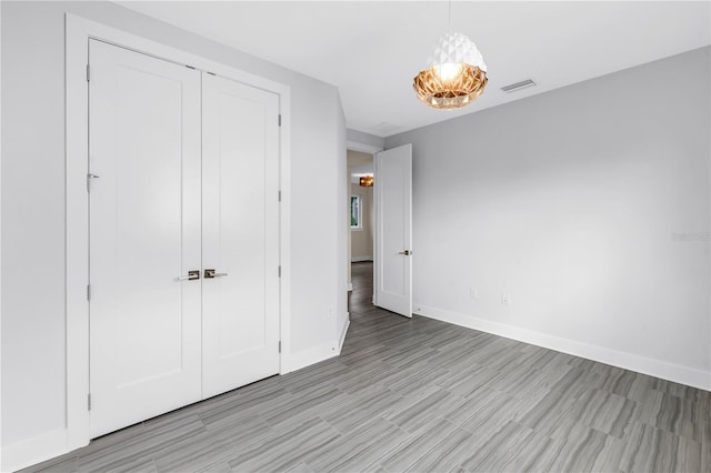 2246 Fiesta Dr, Sarasota, FL 34231 - unfurnished bedroom with light wood-style flooring and a closet