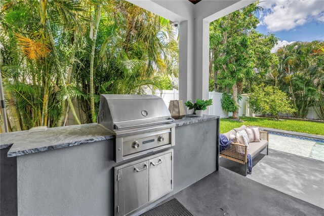 2246 Fiesta Dr, Sarasota, FL 34231 - fenced backyard featuring area for grilling, a patio, and an outdoor living space