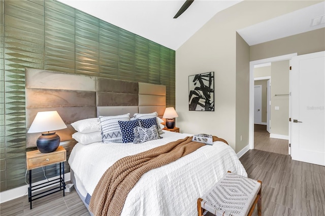 2246 Fiesta Dr, Sarasota, FL 34231 - bedroom with lofted ceiling, wood finished floors, and a ceiling fan