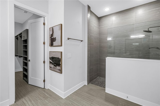 2246 Fiesta Dr, Sarasota, FL 34231 - bathroom with a walk in shower, a walk in closet, and recessed lighting