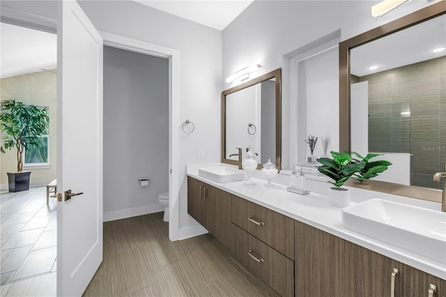 2246 Fiesta Dr, Sarasota, FL 34231 - full bathroom featuring double vanity, tiled shower, and tile patterned floors