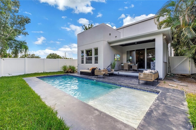 2246 Fiesta Dr, Sarasota, FL 34231 - back of property with an outdoor hangout area, a patio, and a fenced backyard