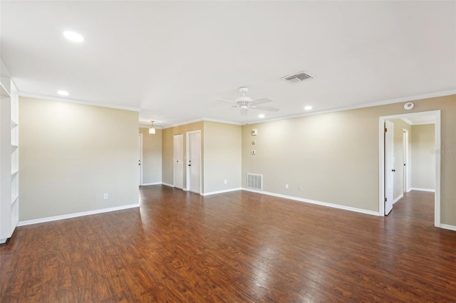 empty room with ceiling fan, ornamental molding, and dark wood-type flooring