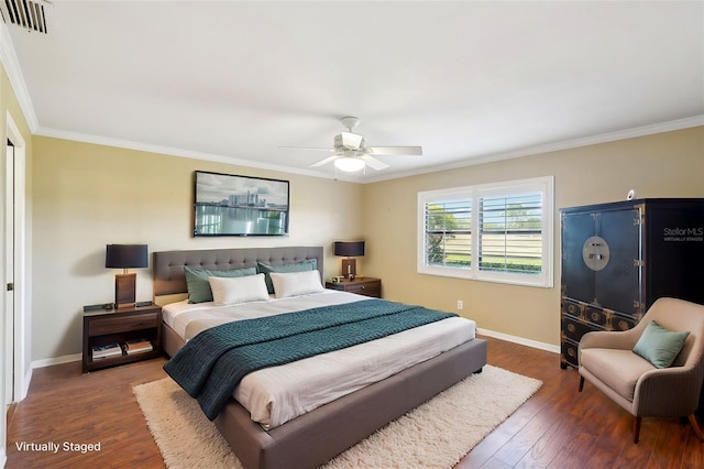 bedroom with dark hardwood / wood-style floors, ceiling fan, and crown molding