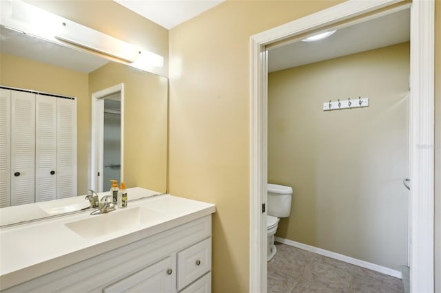 bathroom featuring tile patterned floors, vanity, and toilet