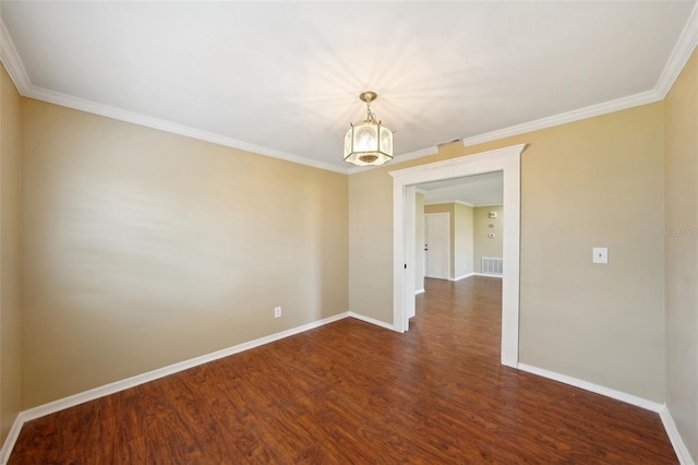 empty room with a chandelier, dark hardwood / wood-style floors, and crown molding