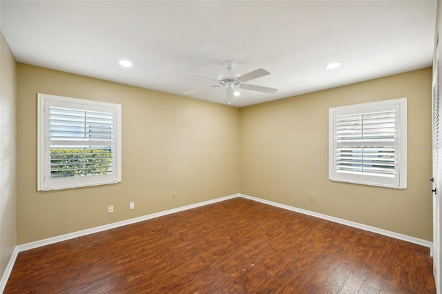 empty room featuring ceiling fan and dark hardwood / wood-style floors