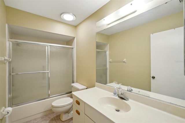 full bathroom with tile patterned flooring, vanity, toilet, and shower / bath combination with glass door