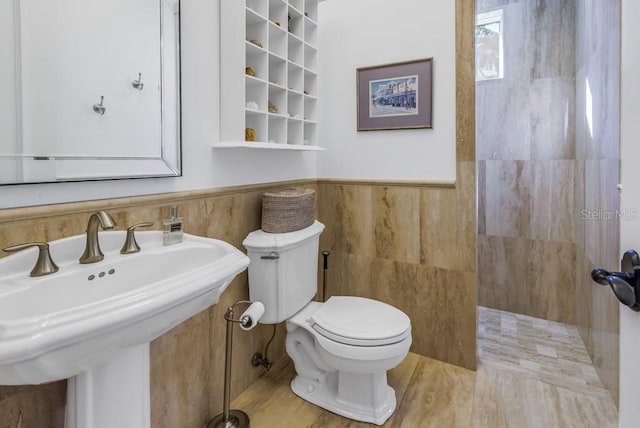 bathroom featuring toilet, wood-type flooring, sink, and walk in shower