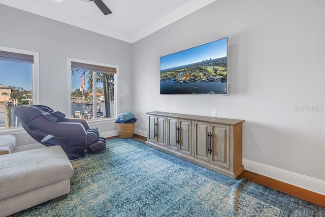 sitting room featuring wood-type flooring, ceiling fan, and ornamental molding