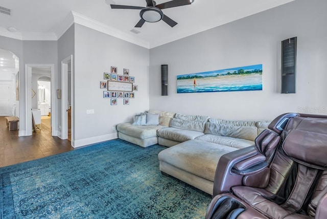 living room with ceiling fan, dark hardwood / wood-style flooring, and crown molding