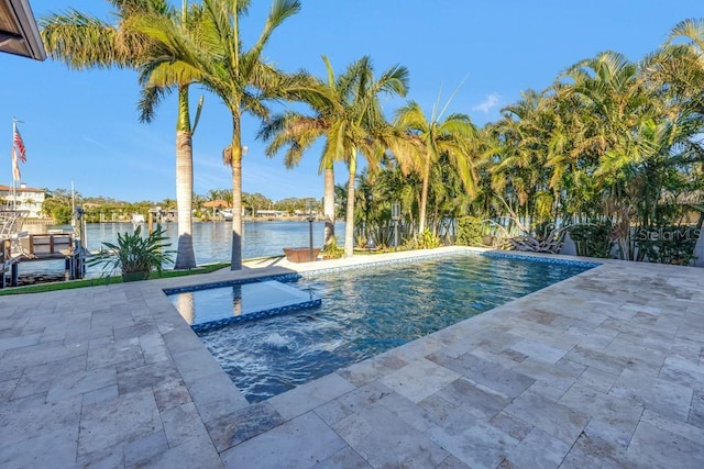 view of swimming pool featuring a patio area, a water view, and a hot tub