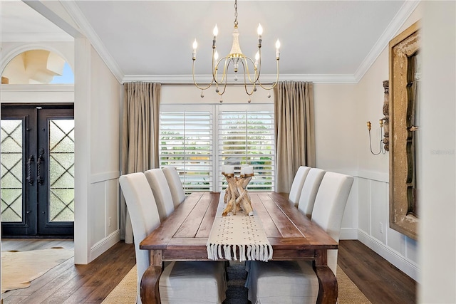 dining space featuring a notable chandelier, dark hardwood / wood-style flooring, crown molding, and french doors