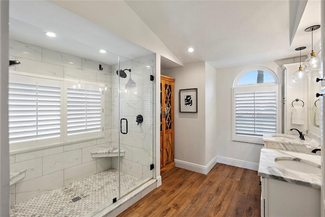 bathroom featuring an enclosed shower, vanity, wood-type flooring, and vaulted ceiling