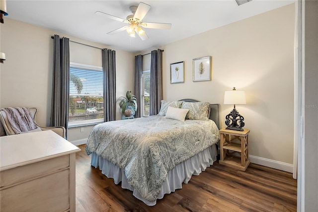 bedroom with ceiling fan and dark wood-type flooring