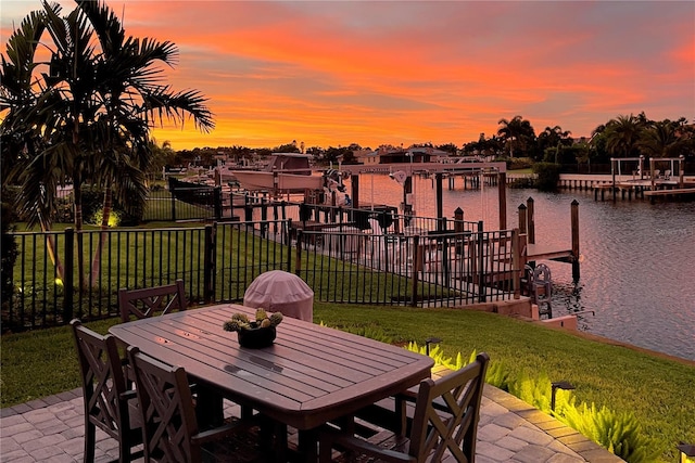 exterior space with a lawn, a water view, and a patio