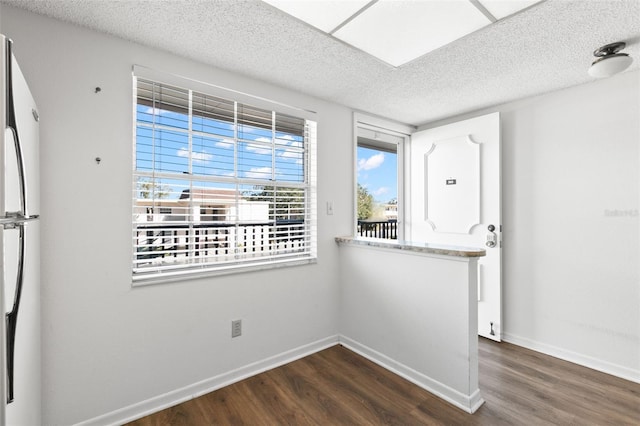 unfurnished room with dark hardwood / wood-style flooring