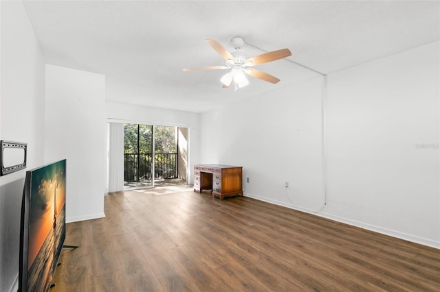 unfurnished living room featuring dark hardwood / wood-style flooring and ceiling fan