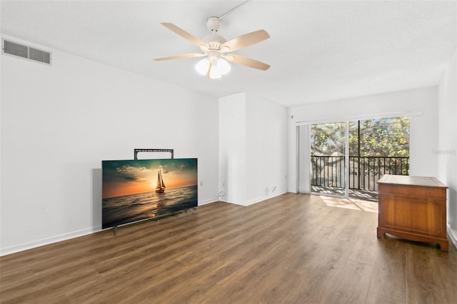 living room with hardwood / wood-style floors, ceiling fan, and a textured ceiling